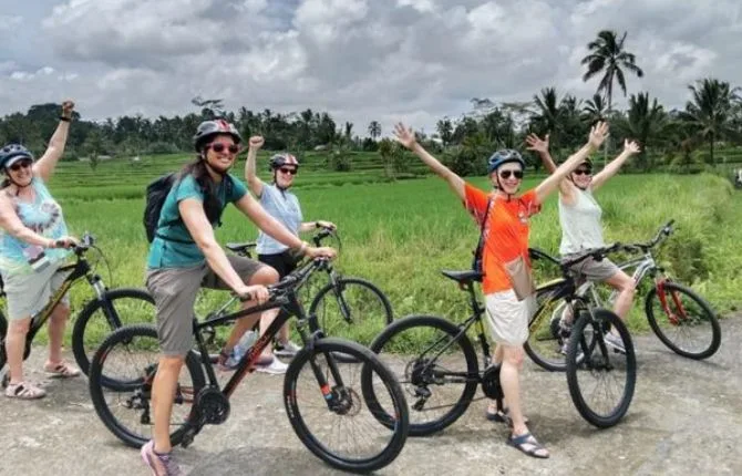 Happy cycling group in Bali rice fields